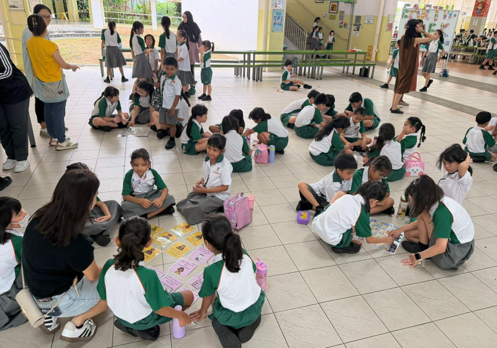 Students taking part in small-group activities during a cyber wellness event.