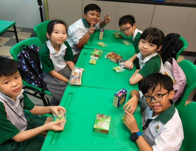Students enjoying snacks together during a classroom break.