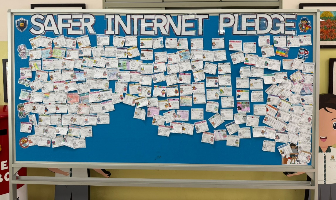 Display board filled with students' safer internet pledge cards.