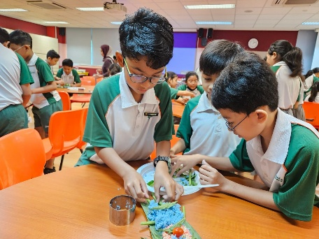 Students preparing food together during a hands-on cooking activity.