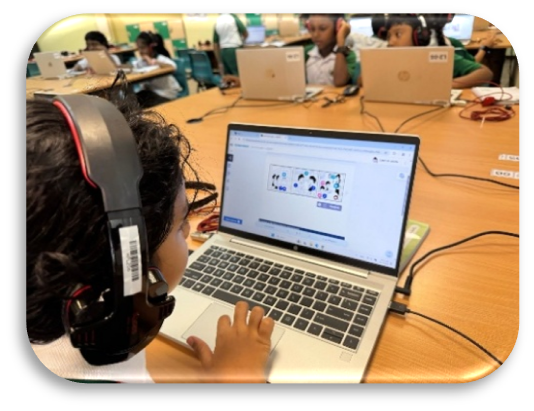 Student using a laptop and headset during an interactive Tamil language lesson.